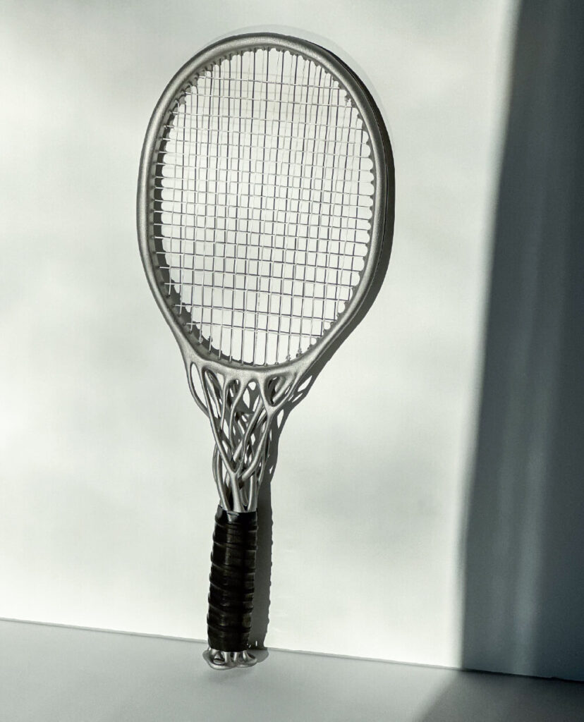 Conceptual organic tennis racket leaning on white wall. Hìtëkw Tennis Racket by All Design Lab.