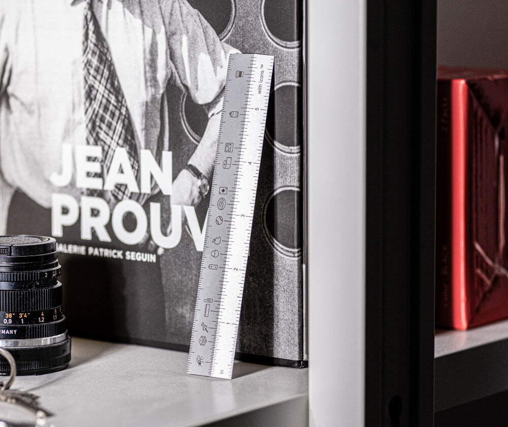 Ruler leaning against book on shelf. Ruler with icons by All Design Lab.